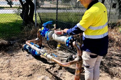Licensed plumber installing backflow prevention valve – Affinity Plumbing & Gas, Perth WA